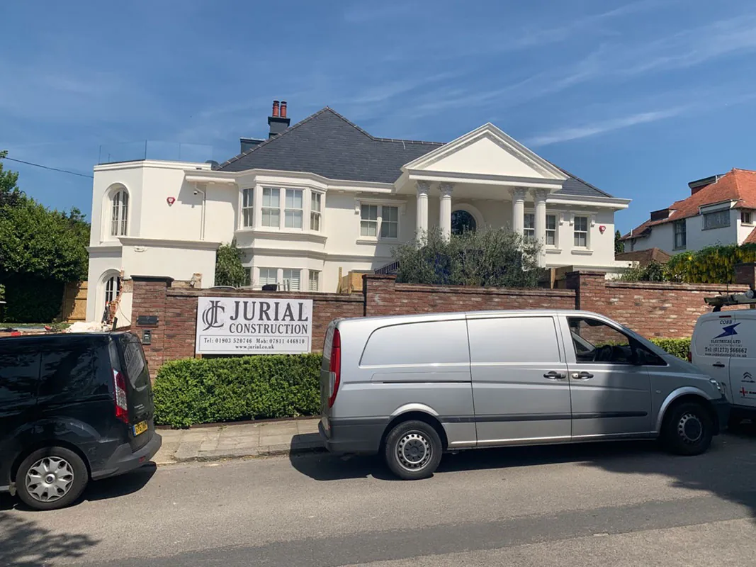 Jurial van and site board outside a finished house