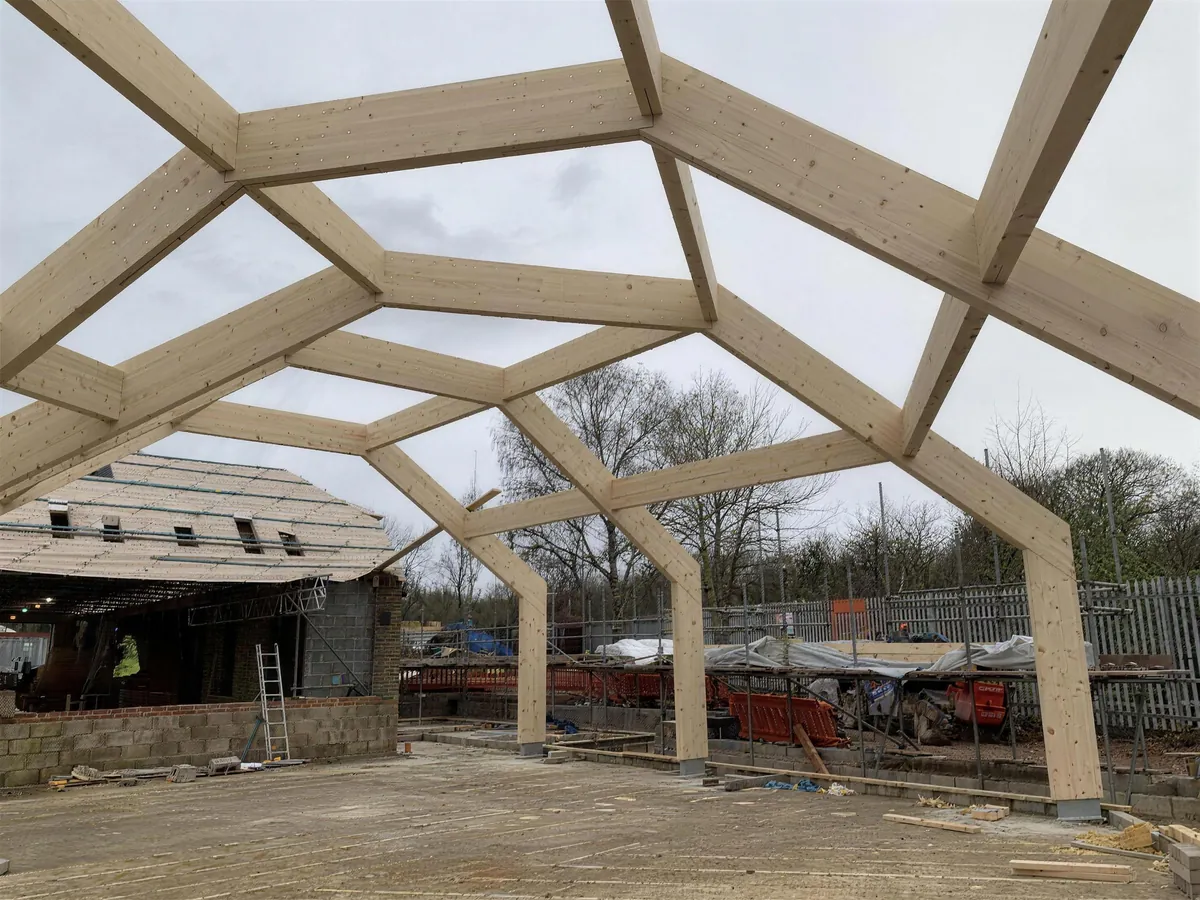 Glulam timber frame of the Link Barn standing against the sky