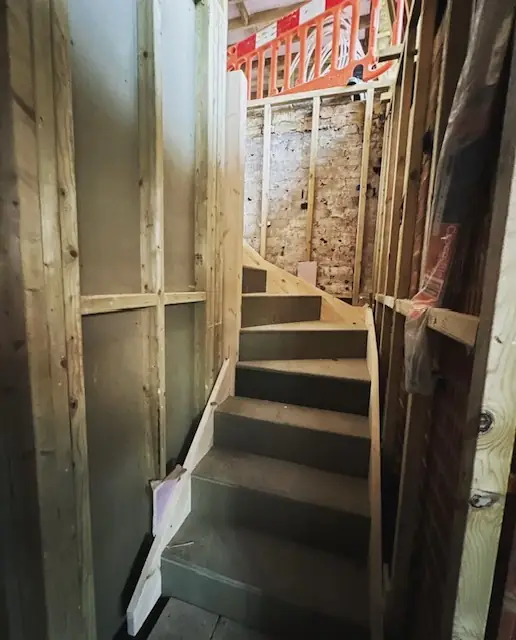 Timber staircase being formed between floors