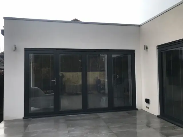Rear extension with grey bi-fold doors and a tiled floor