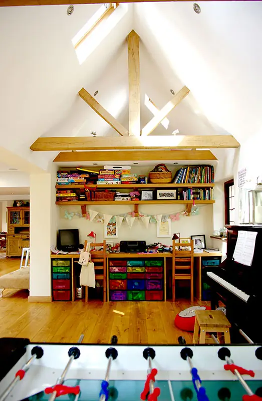 Vaulted room with exposed timber trusses and shelving