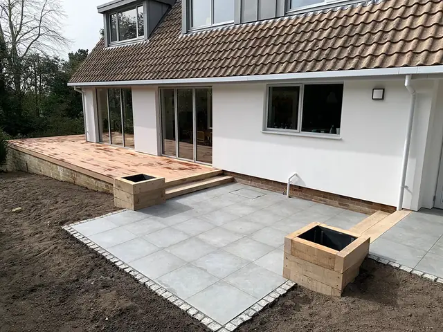 Rear of the house with a new patio, timber planters and decking