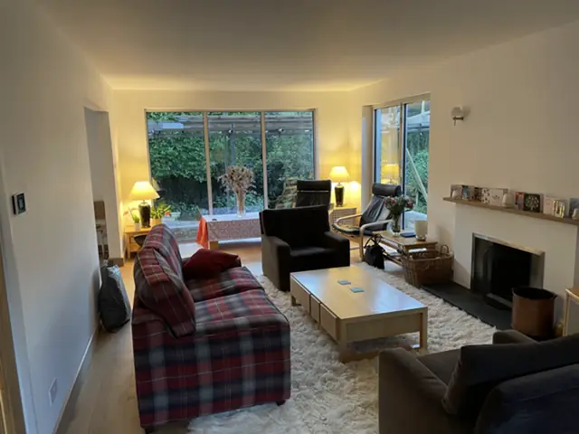 Living room with a fireplace and garden view