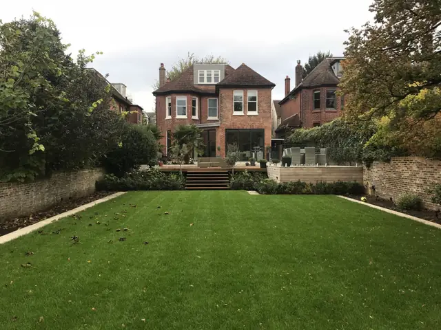 New lawn and borders leading to the terrace and house