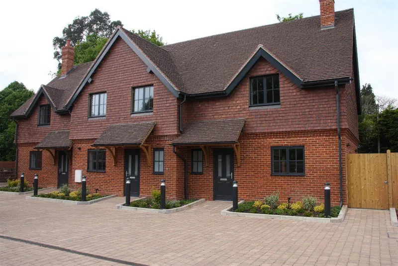 Three new red brick terraced homes built by Jurial at Ladymead, Hurstpierpoint